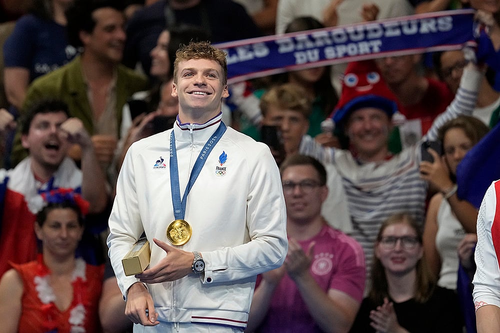 | Photo: AP/Ashley Landis : Leon Marchand after receiving his gold medal in men's 200-meter individual medley final